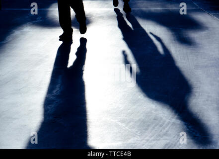 Blurry reflection shadow silhouette of mysterious men walking in the  black and white night Stock Photo