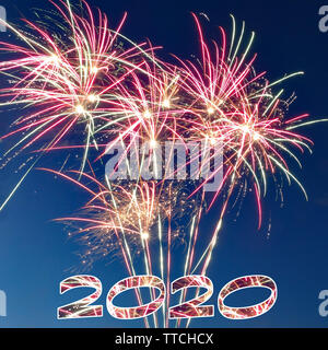 2020 new year greeting card with fireworks on dark blue background Stock Photo