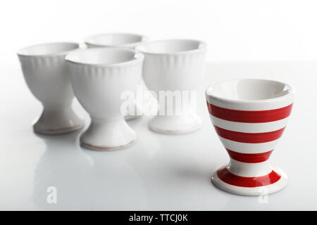 Red and White stripe egg cups, isolated on white Stock Photo