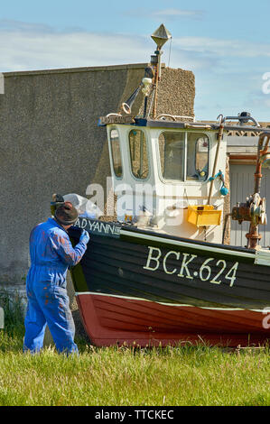 PORTGORDON MORAY SCOTLAND PAINTER AND FISHING BOAT Stock Photo