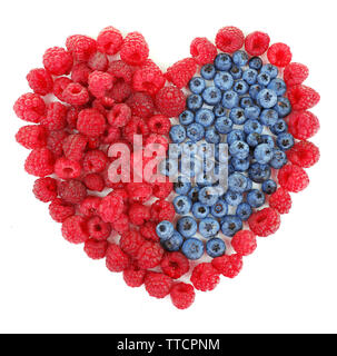 Heart shaped raspberries and blueberries isolated on white Stock Photo
