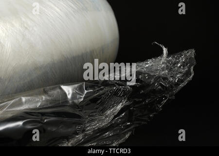 plastic food wrap on a black background Stock Photo