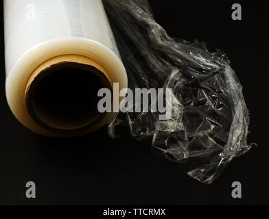 plastic food wrap on a black background Stock Photo