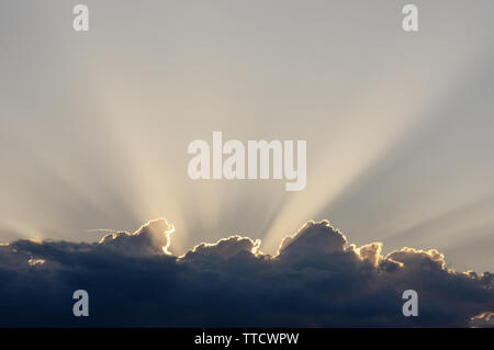 Sun behind a cloud, with cloud rays Stock Photo