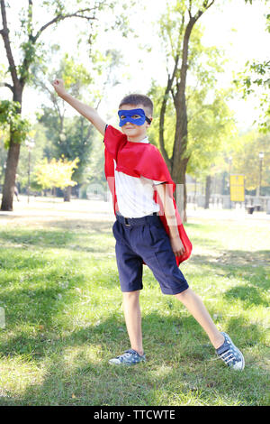 Boy dressed as superhero with boxing gloves poses in studio isolated on ...