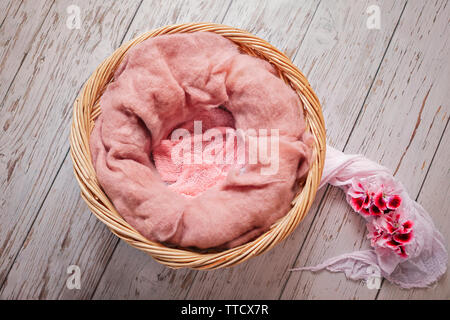 Digital backdrop... newborn basket with pink fluffy wool and pink flowers Stock Photo