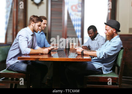 Young men talking in cafe Stock Photo