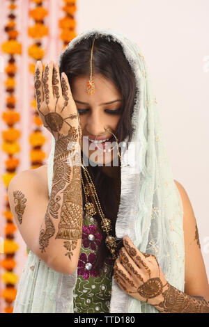 Indian bride posing with her mehndi art on hands. | Photo 228309