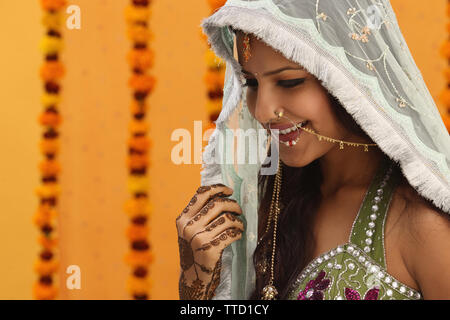 Indian bride wearing a stole smiling Stock Photo