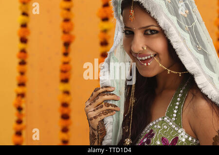 Indian bride wearing a stole smiling Stock Photo