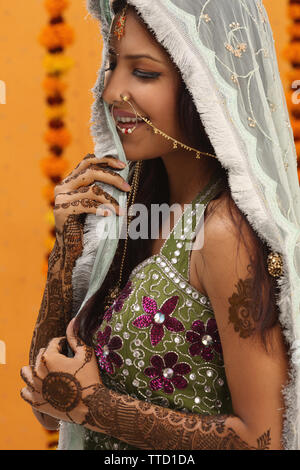 Indian bride wearing a stole smiling Stock Photo