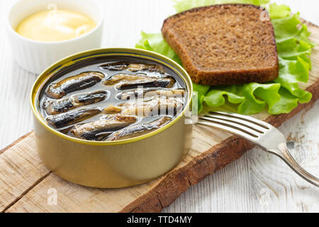 Canned sprats in tin can with bread for sandwich Stock Photo