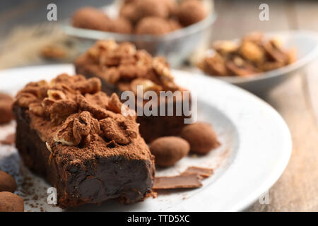 Pieces of chocolate cake with walnut on the table, close-up Stock Photo