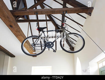 Mens bicycle being stored in the rafters of a house Stock Photo