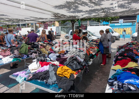 Piles of clothes for browsing in a sale at a local spanish clothes market Stock Photo