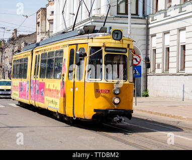 Iasi, Romania - August 6th, 2018: A yellow, electricity powered, city tram in Iasi, Romania Stock Photo