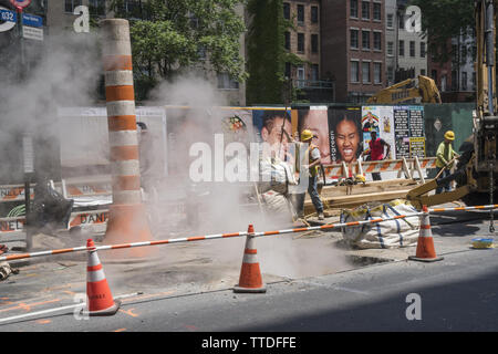 Steam rising out from under the street as infrastructure work goes on on 60th Street near Lexington Avenue on the East Side of Manhattan. Stock Photo