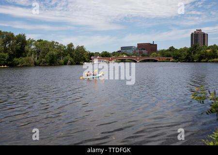 Boaters paddle a kayak down the Charles River from the Christian Herter Park boat rental in Allston Brighton in Boston, Massachusetts, USA. Stock Photo