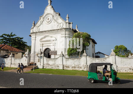 A Tuk Tul drives in front of the Reformed Dutch Church in Galle Fort, Galle, Sri Lanka Stock Photo