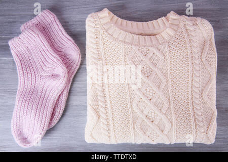Hand made warm clothes on wooden background Stock Photo