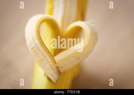 Heart made of banana on wooden background Stock Photo