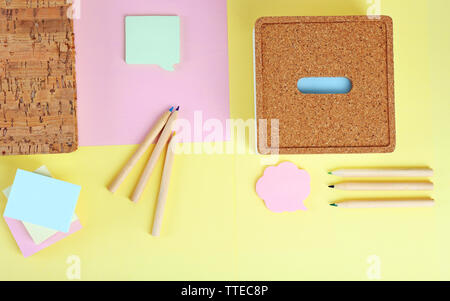 Pencils, stickers and notebook on coloured paper Stock Photo