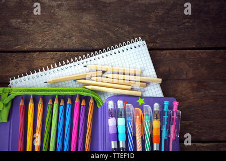 Pencil case with various stationery on old  wooden table Stock Photo
