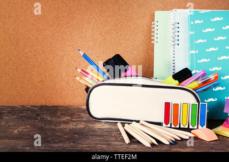 Pencil case with various stationery on old  wooden table Stock Photo