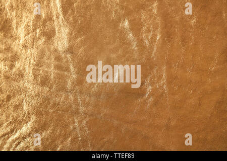 Golden leather texture with crumpled uneven surface Stock Photo