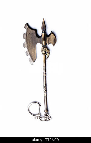 Close up of Axe key chain of golden color isolated on white. Stock Photo