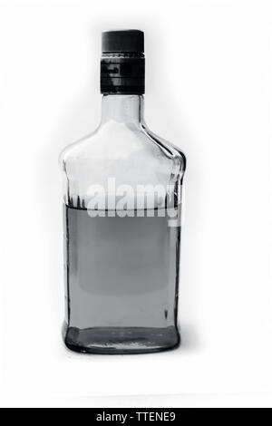 Scotch or whisky or whiskey bottle isolated on white with half filled in it,Close up view along with top shot. Stock Photo
