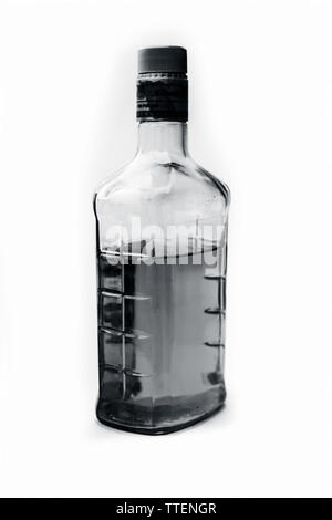 Scotch or whisky or whiskey bottle isolated on white with half filled in it,Close up view along with top shot. Stock Photo