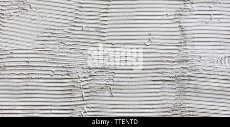 surface of the wall covered with adhesive gray plaster. striped gray texture. renovation concept Stock Photo