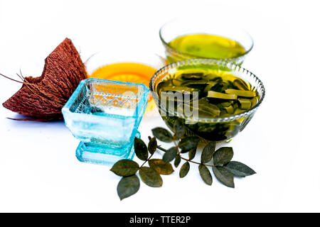 Hair growth therapy isolated on white i.e. coconut oil,honey and aloe vera gel in a transparent glass bowl with raw coconut oil,aloe vera gel and hone Stock Photo