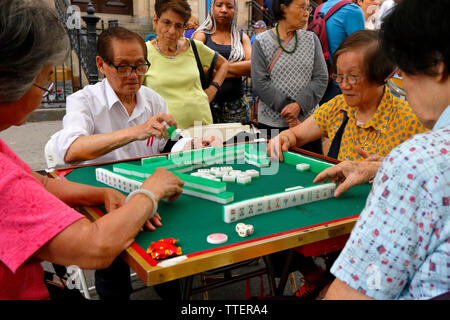 Chinese American senior citizens play Mah Jongg at the 2019 Egg Rolls, Egg Creams and Empanadas Festival on Eldridge St, New York, June 16, 2019 Stock Photo