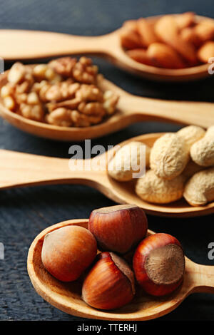 Spoons with hazelnuts, walnuts, almonds and peanuts, close-up Stock Photo