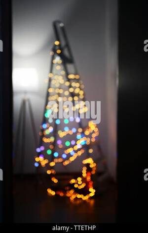 Blurred electric garland on a leader over wall background Stock Photo