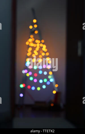 Blurred electric garland on a leader over wall background Stock Photo