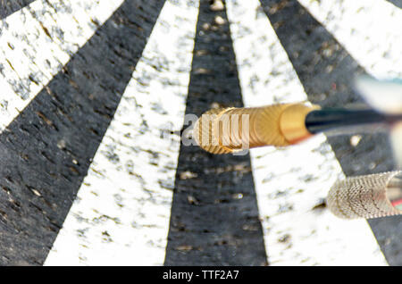 Darts on a Worn Out Dartboard. Proper Targeting Concept. Stock Photo
