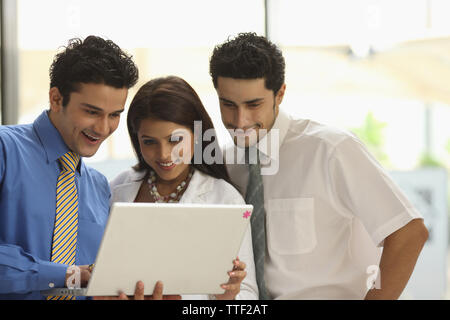 Three office workers working in an office Stock Photo