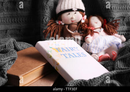 Rag dolls with fairy tales books  on bedspread. Childhood concept Stock Photo