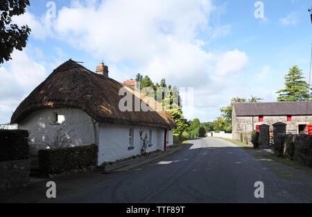 Traditional thatched cottage farmhouse and peat farm on a lonely road, County Westmeath, Ireland Stock Photo