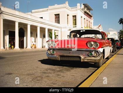 Red vintage car on the streets of Trinidad, Cuba. Stock Photo