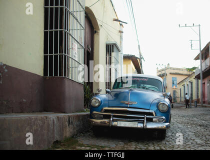 Blue vintage car on the cobblestone streets of Trinidad, Cuba. Stock Photo