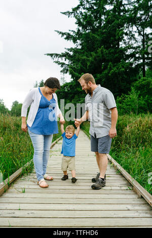Straight on view of a family of three playing together Stock Photo