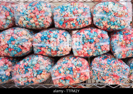 Packaged popcorn dyed with red and blue color to mimic the colors of the American Flag, sold by a vender at a festival in Owego, New York, USA. Stock Photo