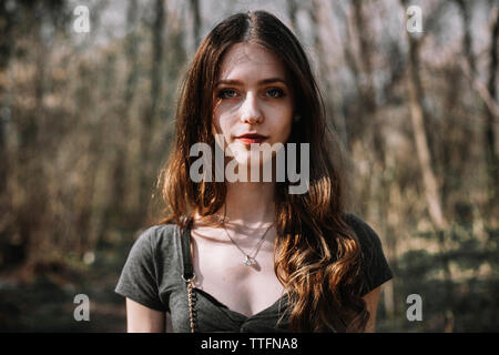 Portrait of confident young woman at forest Stock Photo