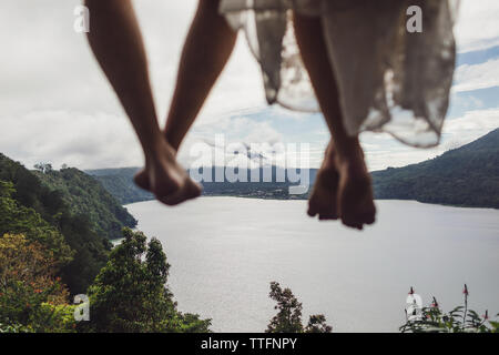 Blurred feet of traveler family above mountain high view of beautiful lake. Freedom and travel concept. Stock Photo