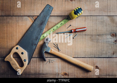 Overhead image of woodworking tools scattered on a wooden table. Stock Photo