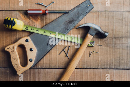 Overhead image of woodworking tools scattered on a wooden table. Stock Photo